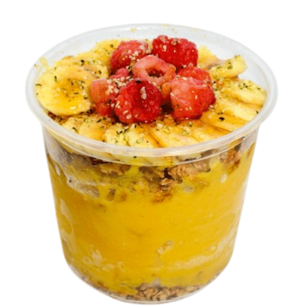 Tropical mango smoothie bowl topped with banana slices, raspberries, hemp seeds, and granola