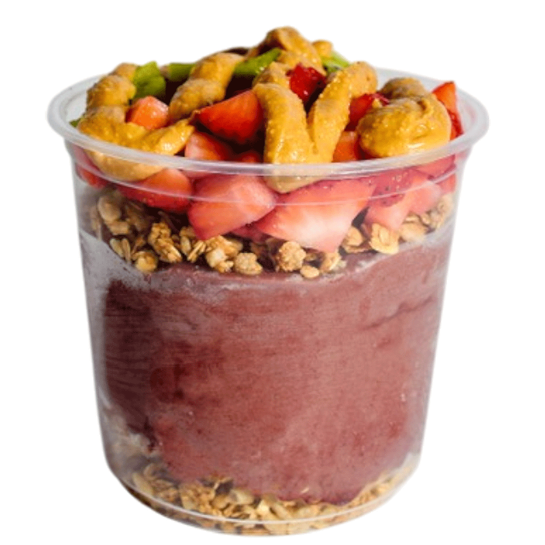 Acai smoothie bowl topped with strawberries, granola, and drizzled almond butter